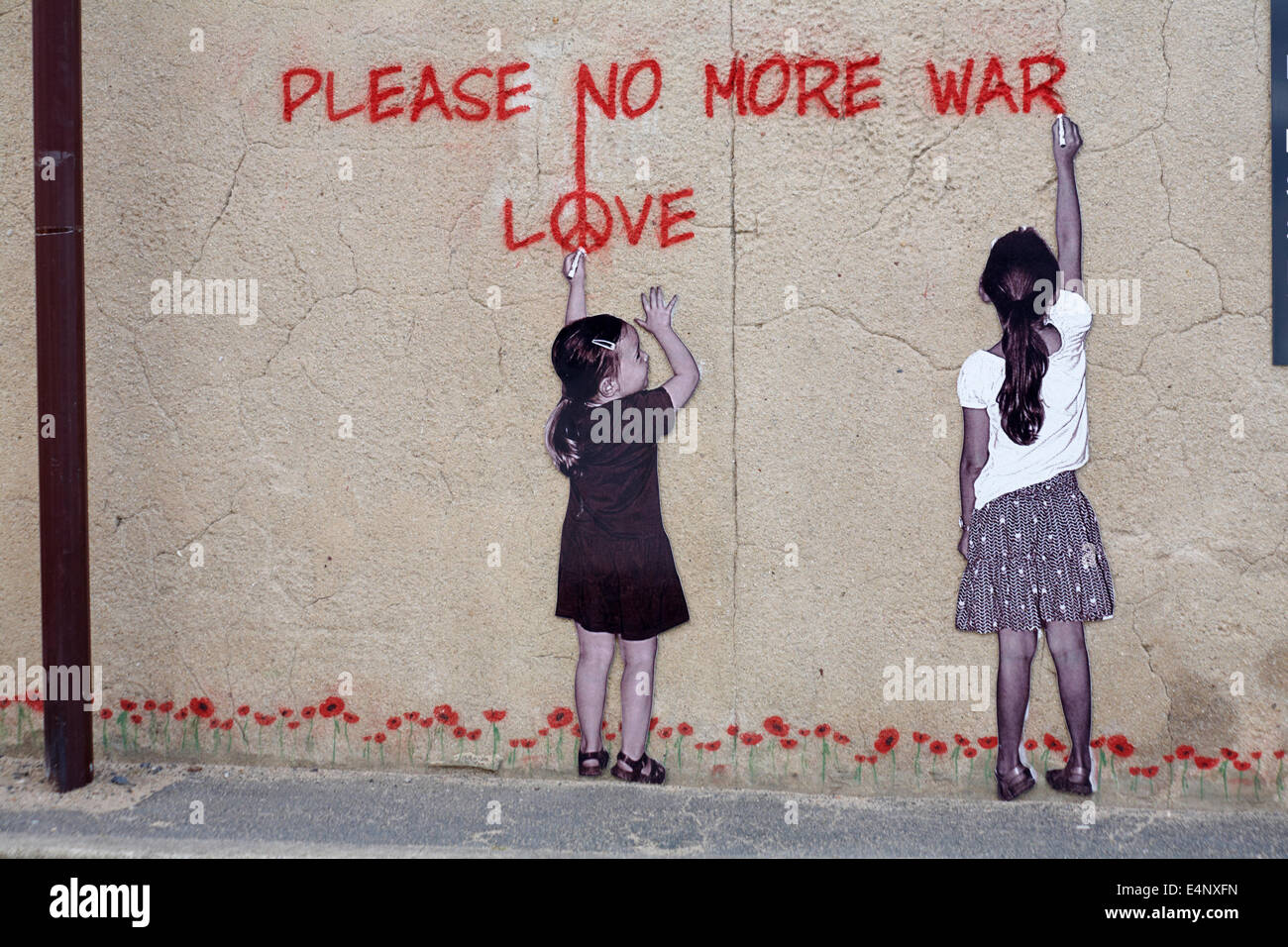 painting of two girls writing Please no more war Love on wall in Arromanches Normandy France in July Stock Photo