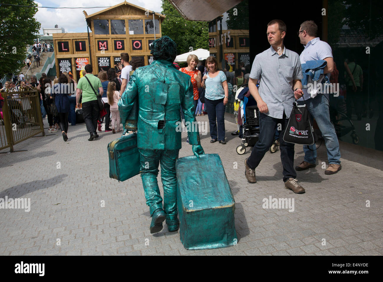 Living statue artist street performer walks off to take a break on the
