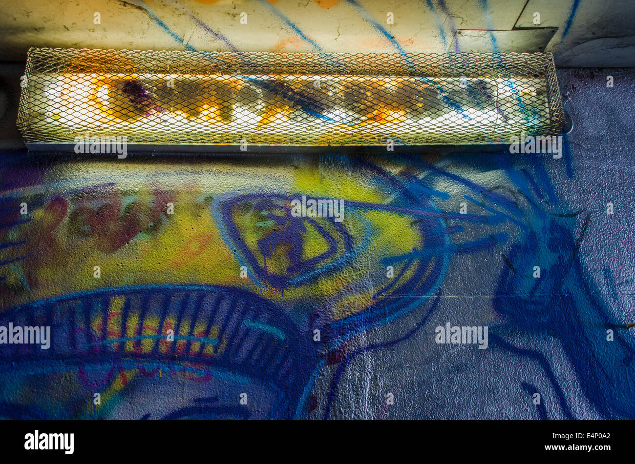 cement walls smeared with graffiti and long nightlight Stock Photo