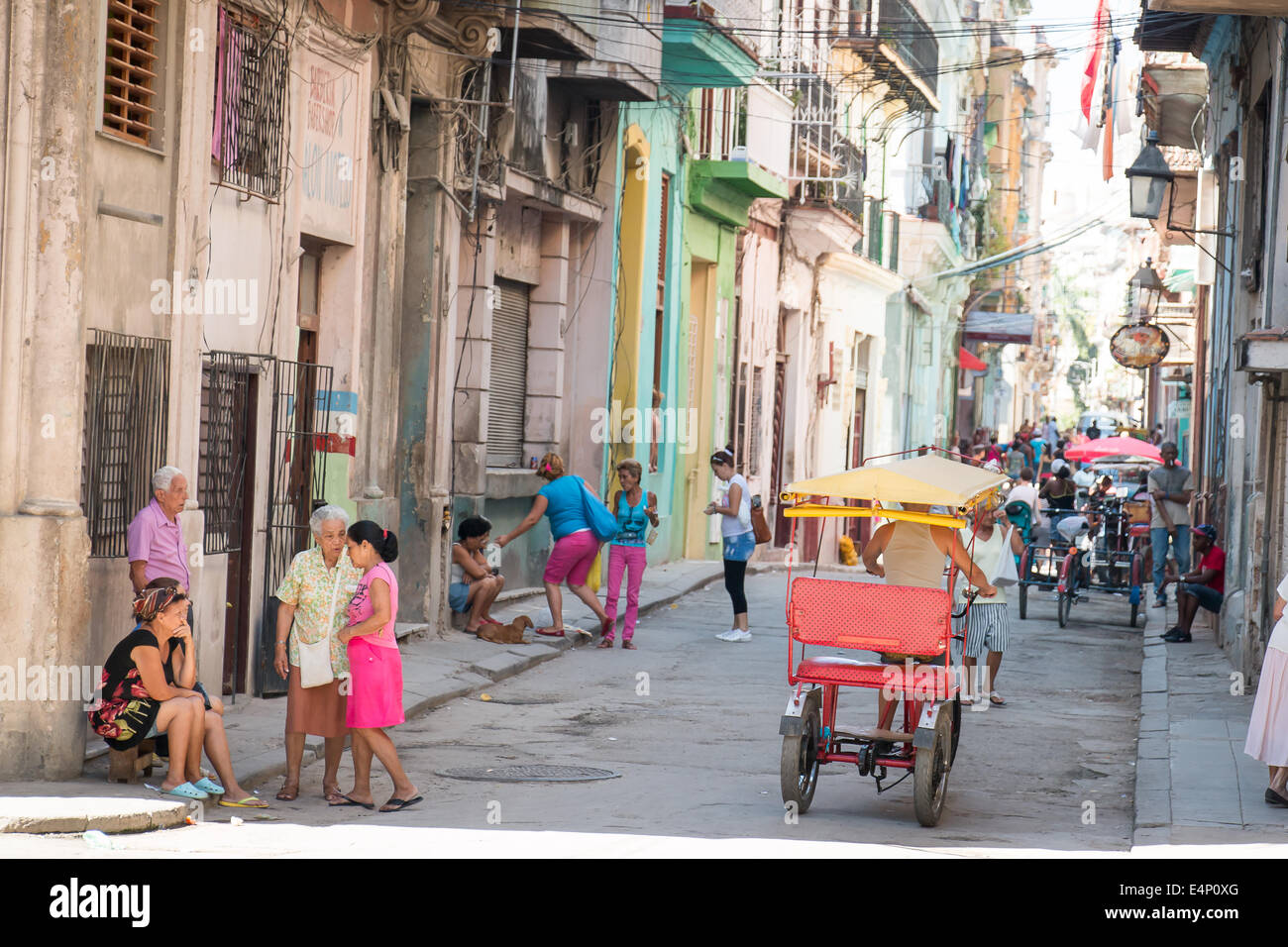 Street scene with tricycle taxi and people talking, Havana Vieja (Old Havana), Havana, Cuba Stock Photo
