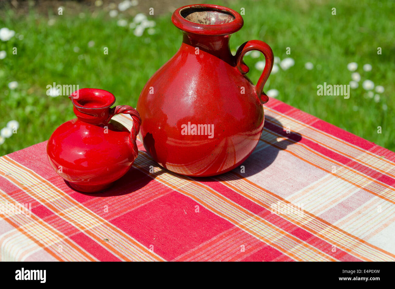 large and small red retro vintage clay jugs outdoor Stock Photo