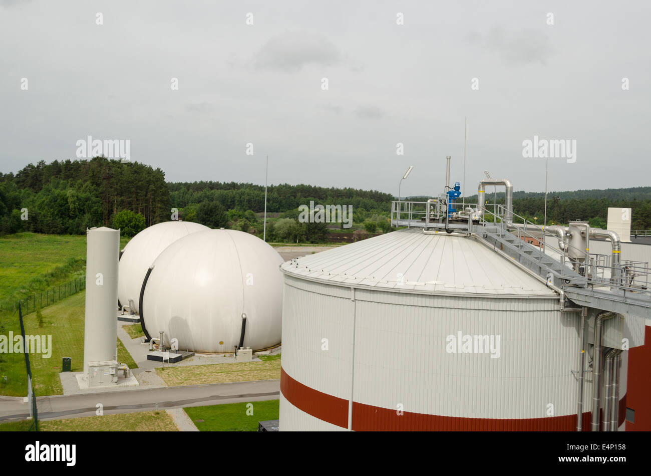Modern biogas plant using water treatment facility sludge as renewable form of energy process. Stock Photo