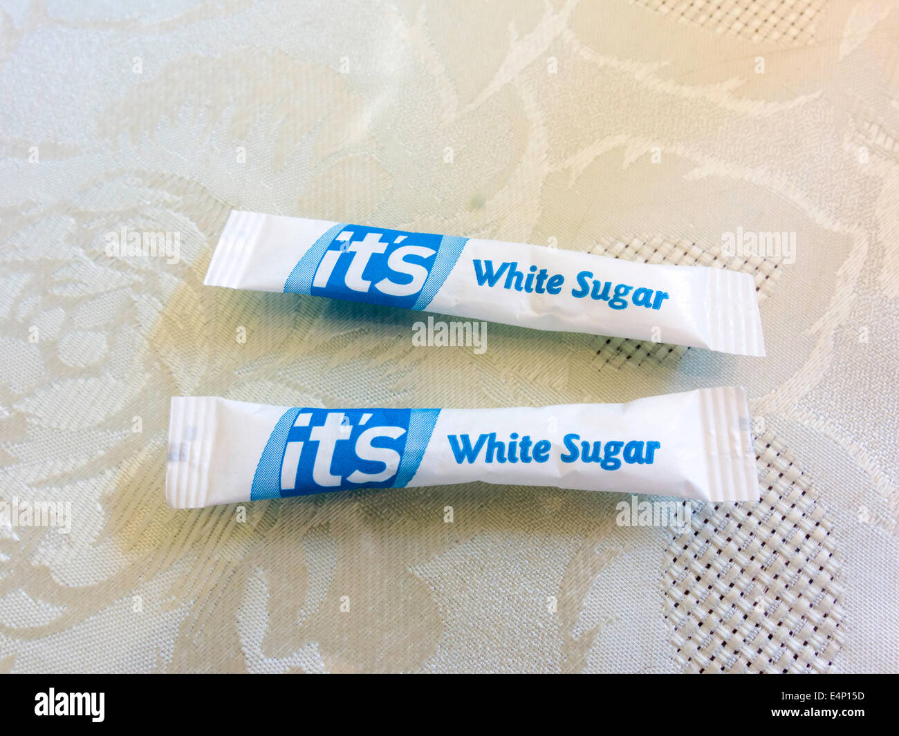 Two sachets of white sugar in a café for sweetening tea Stock Photo
