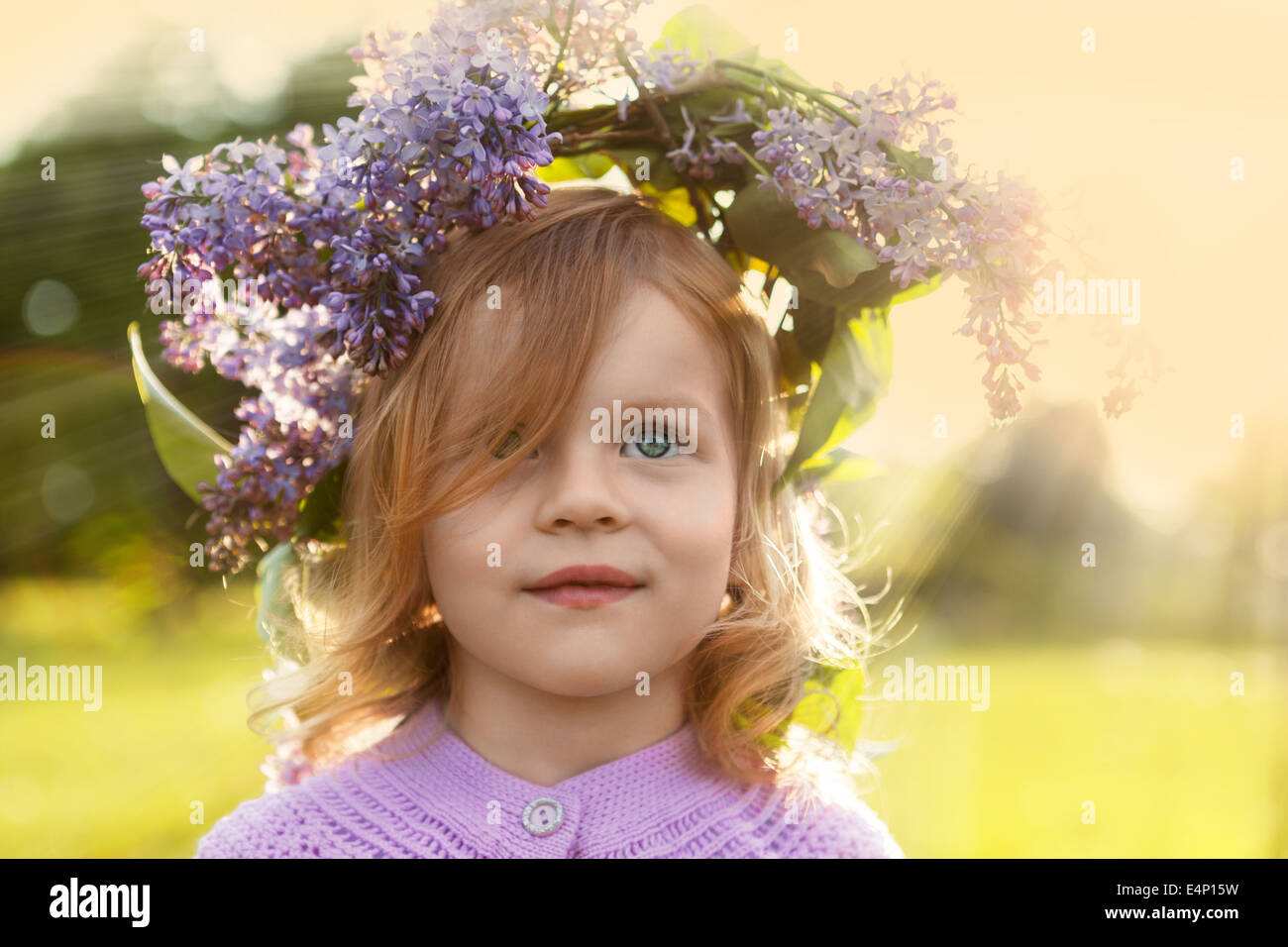 Little summer girl in lilac flowers garland Stock Photo Alamy