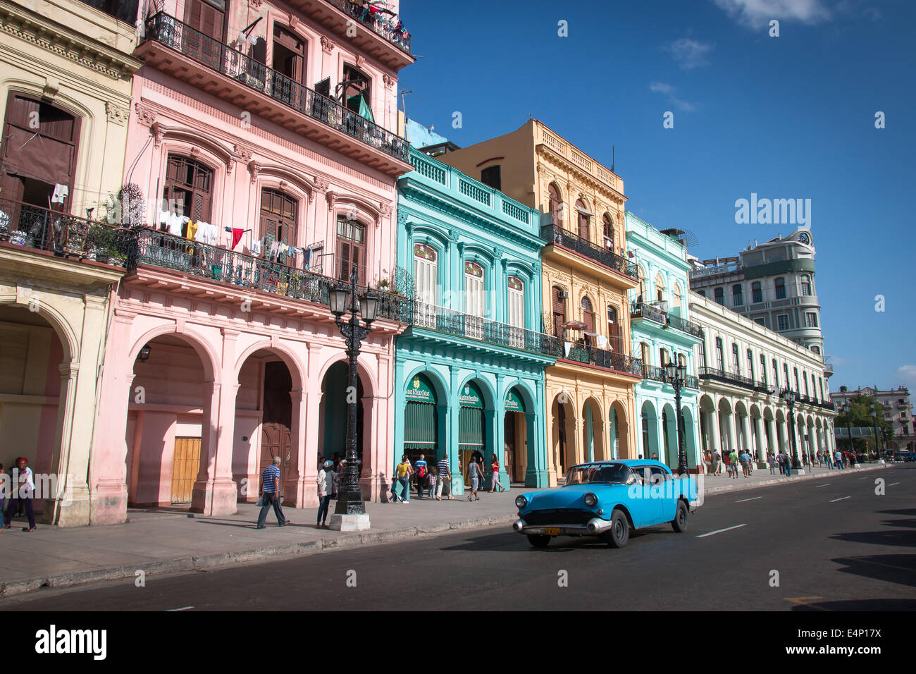 Pastel painted buildings with antique car in foreground, Capitolio, Havana, Cuba Stock Photo