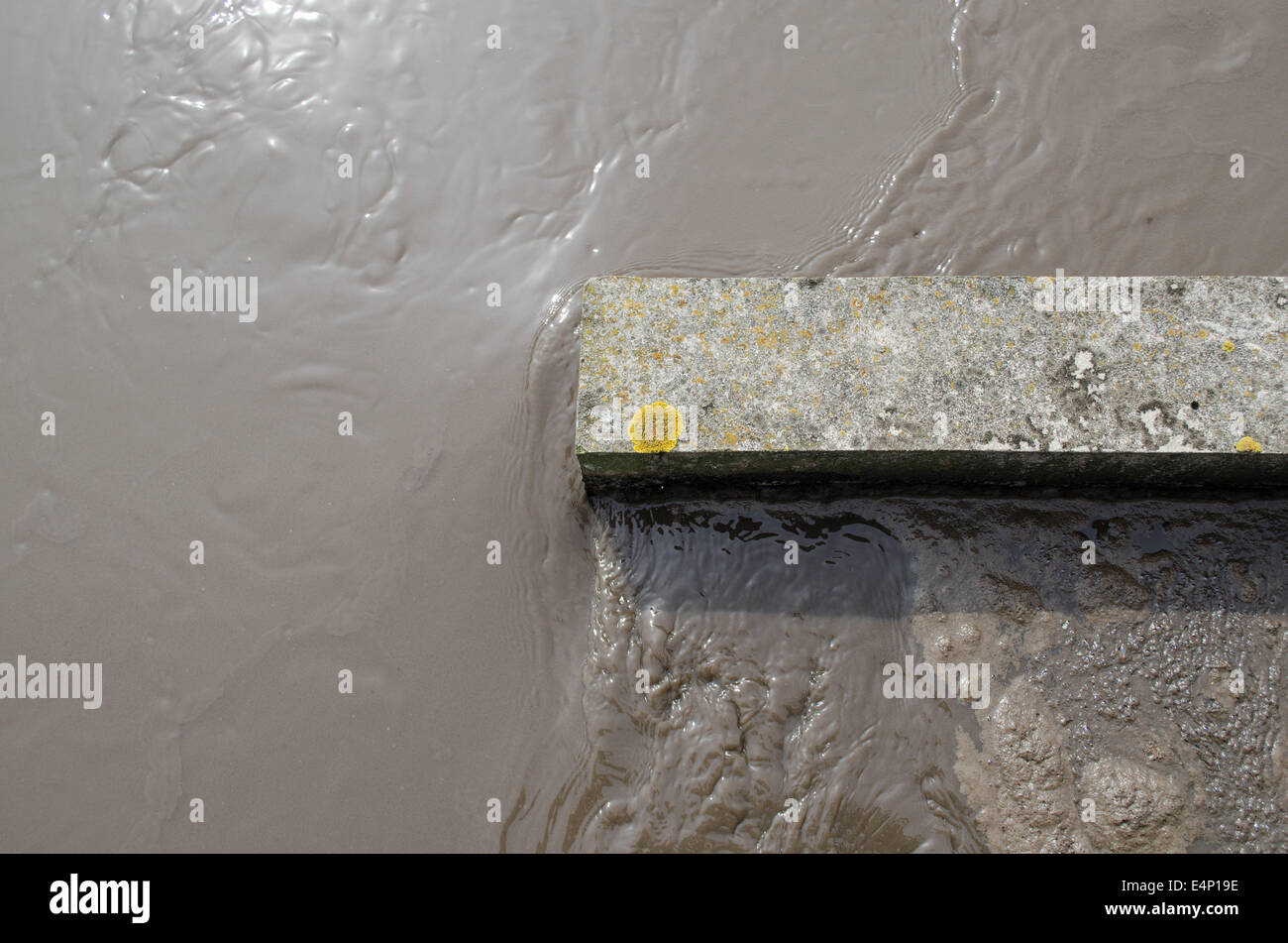 Dirty sewage water flow in aerated grit chamber treatment plant stage. Stock Photo