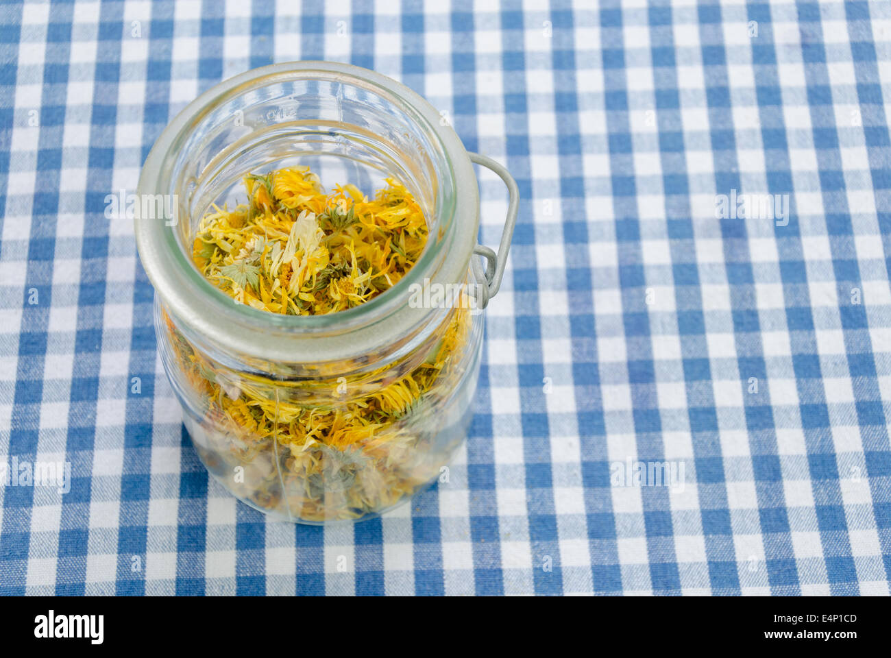 jar of dried organic herbal healing calendula on table Stock Photo