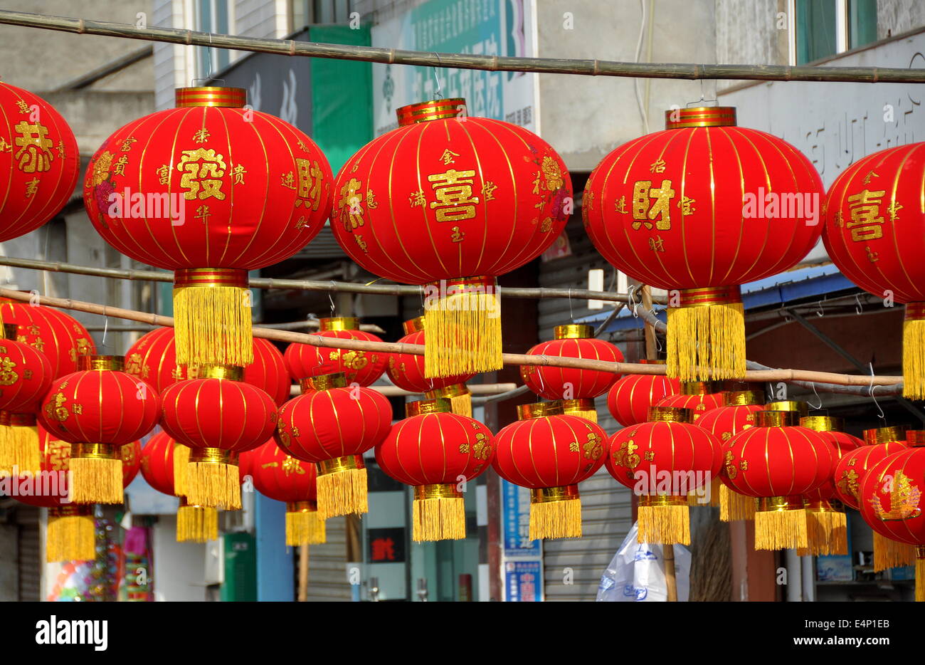Jun Le, china:  Rows of bright red lanterns for the Chinese Lunar New Year holiday hang in front of a hardware store Stock Photo