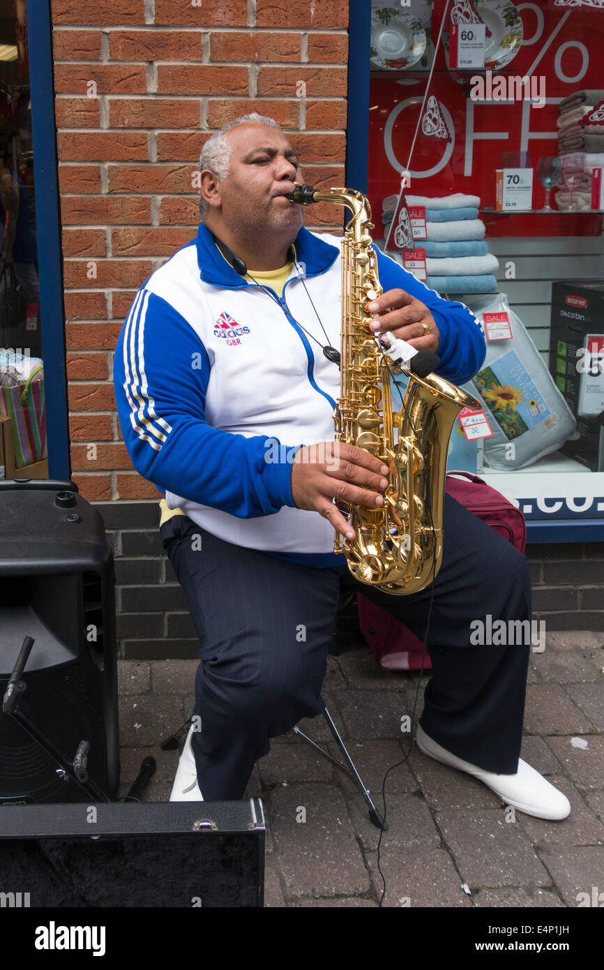 Street musician playing a saxophone in Redcar town centre Stock Photo