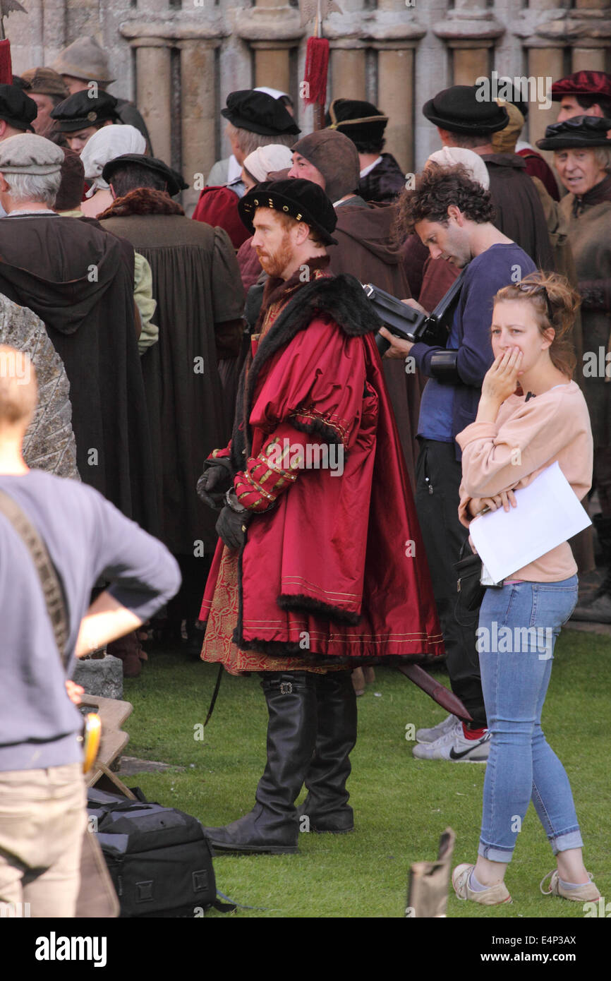 Wells, Somerset, UK. 15th July, 2014. The BBC are filming a new drama called 'Wolf Hall' based on the book by Hilary Mantel. The six part series focuses on the politics of despotism between King Henry VIII and Thomas Cromwell. Actor Damian Lewis plays King Henry VIII shown here. Filming took place at Wells Cathedral today and the series will be screened in early 2015. Stock Photo