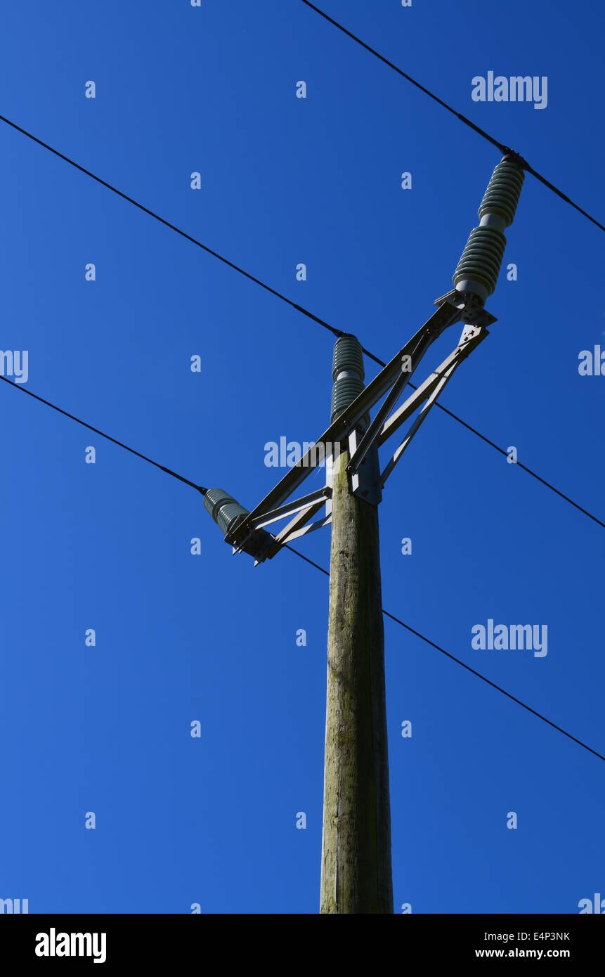 British rural wood electricity pole under a clear blue sky. Stock Photo