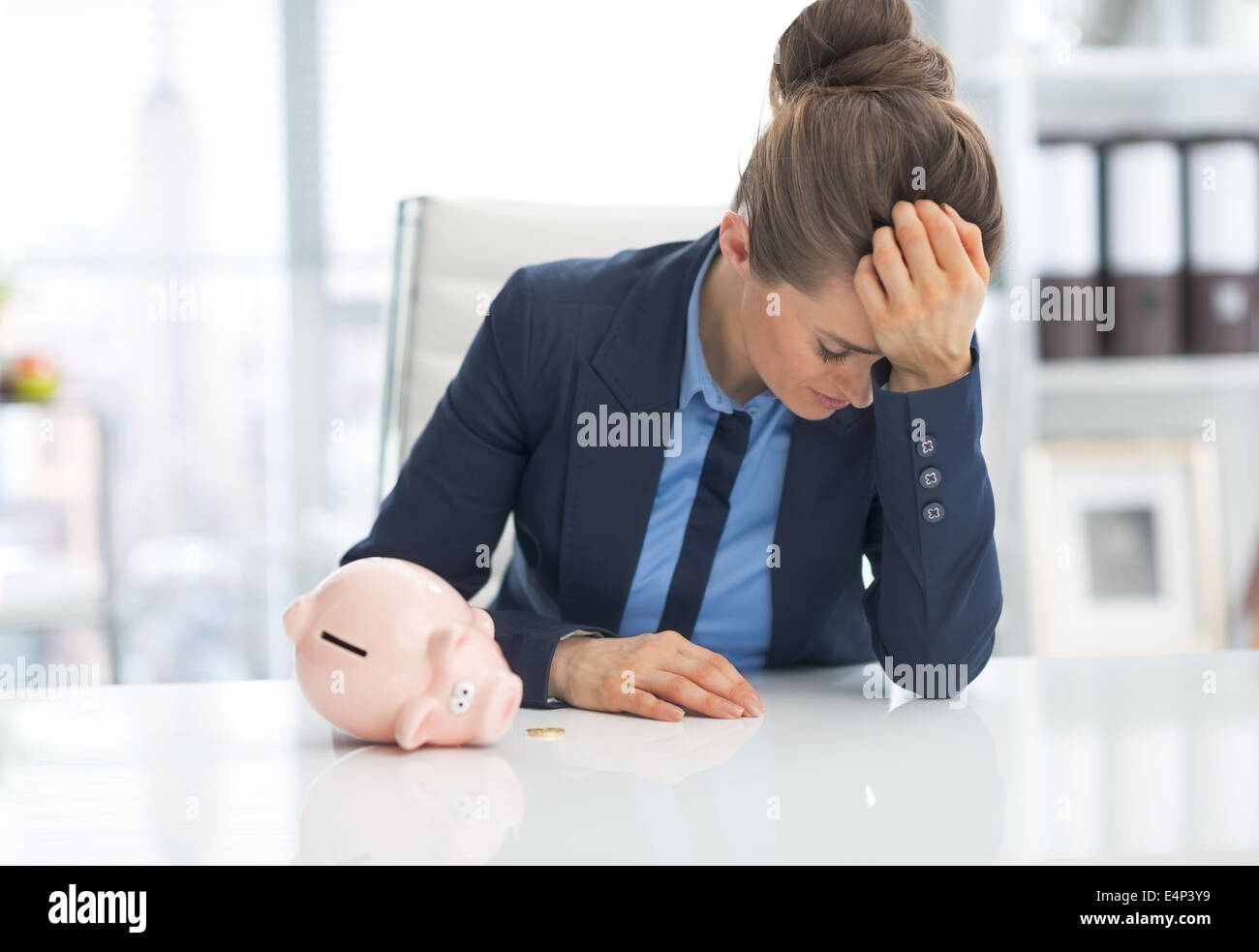Frustrated business woman with piggy bank Stock Photo - Alamy