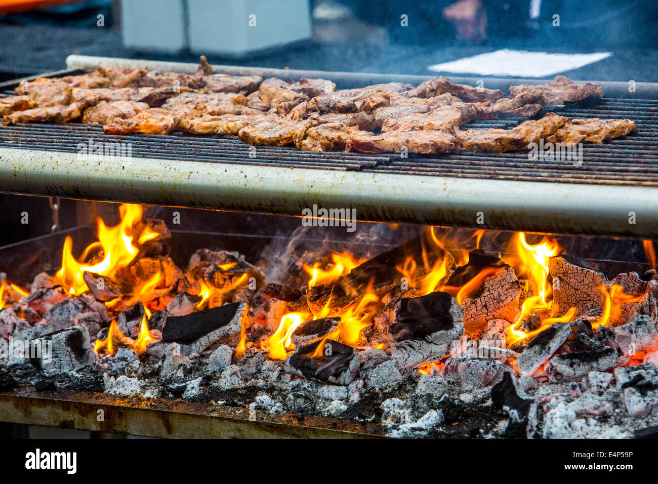 Pork steaks are grilled on a charcoal grill, Stock Photo