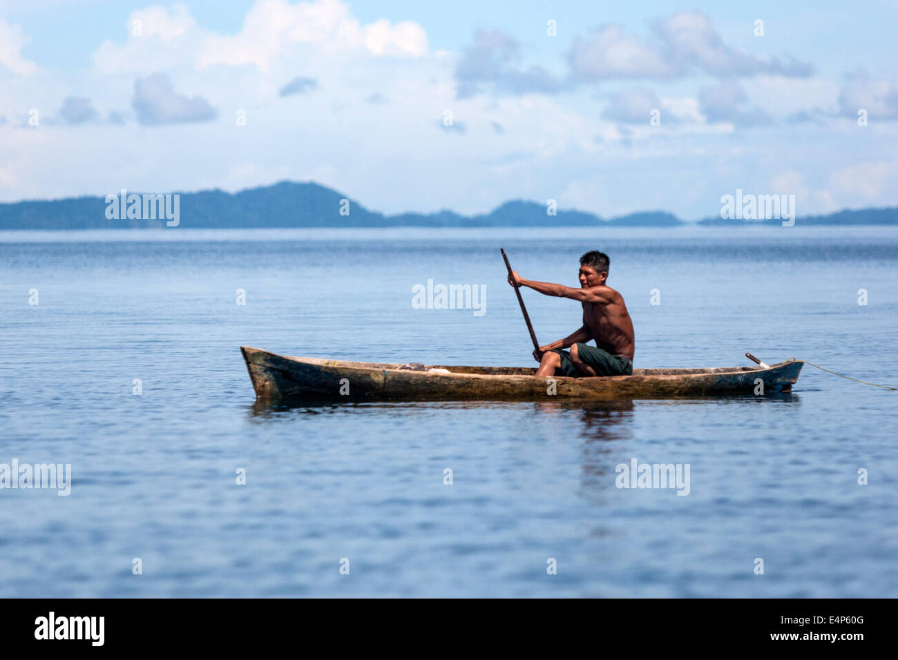 Local man rowing in a kayak in the Caribbean sea . Bocas del Toro ...