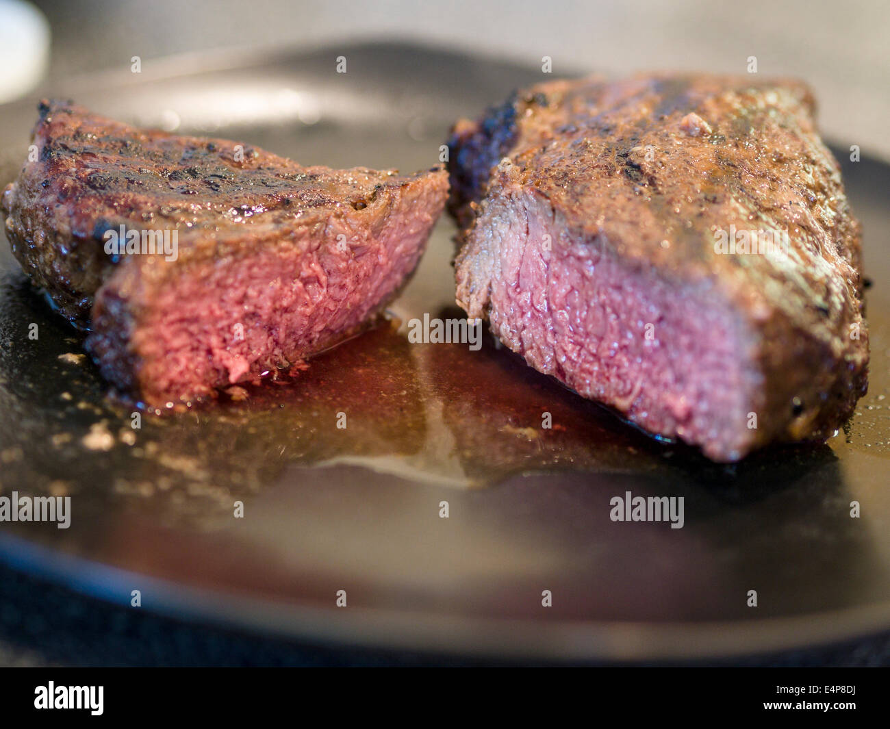 Venison Steak cut. A cooked venison steak cut in two pieces to reveal its pink interior. Ottawa