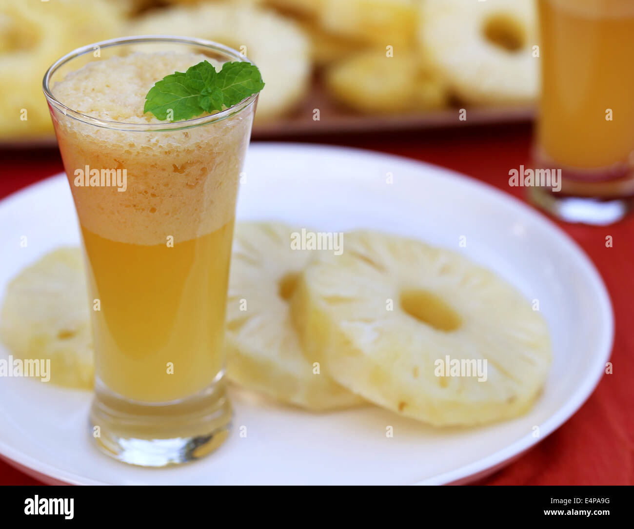 Sliced pineapple with juice in glass Stock Photo