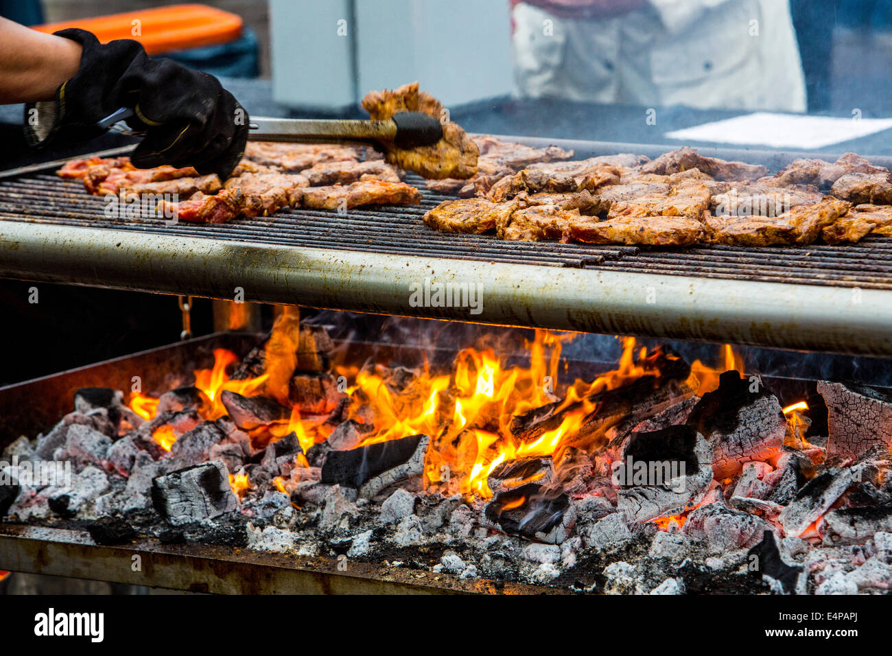 Pork steaks are grilled on a charcoal grill, Stock Photo