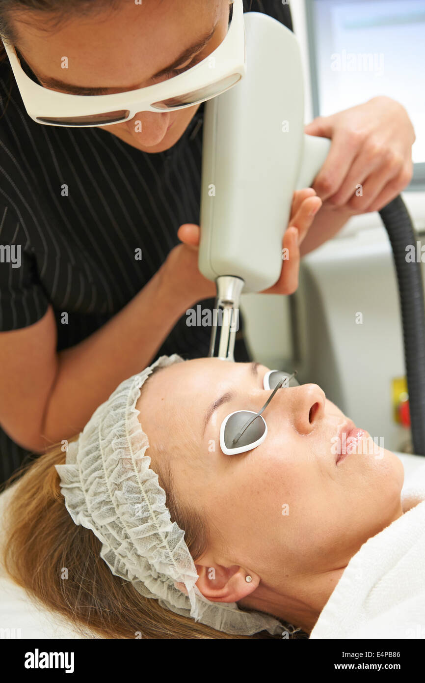 Beautician Carrying Out Fractional Laser Treatment Stock Photo