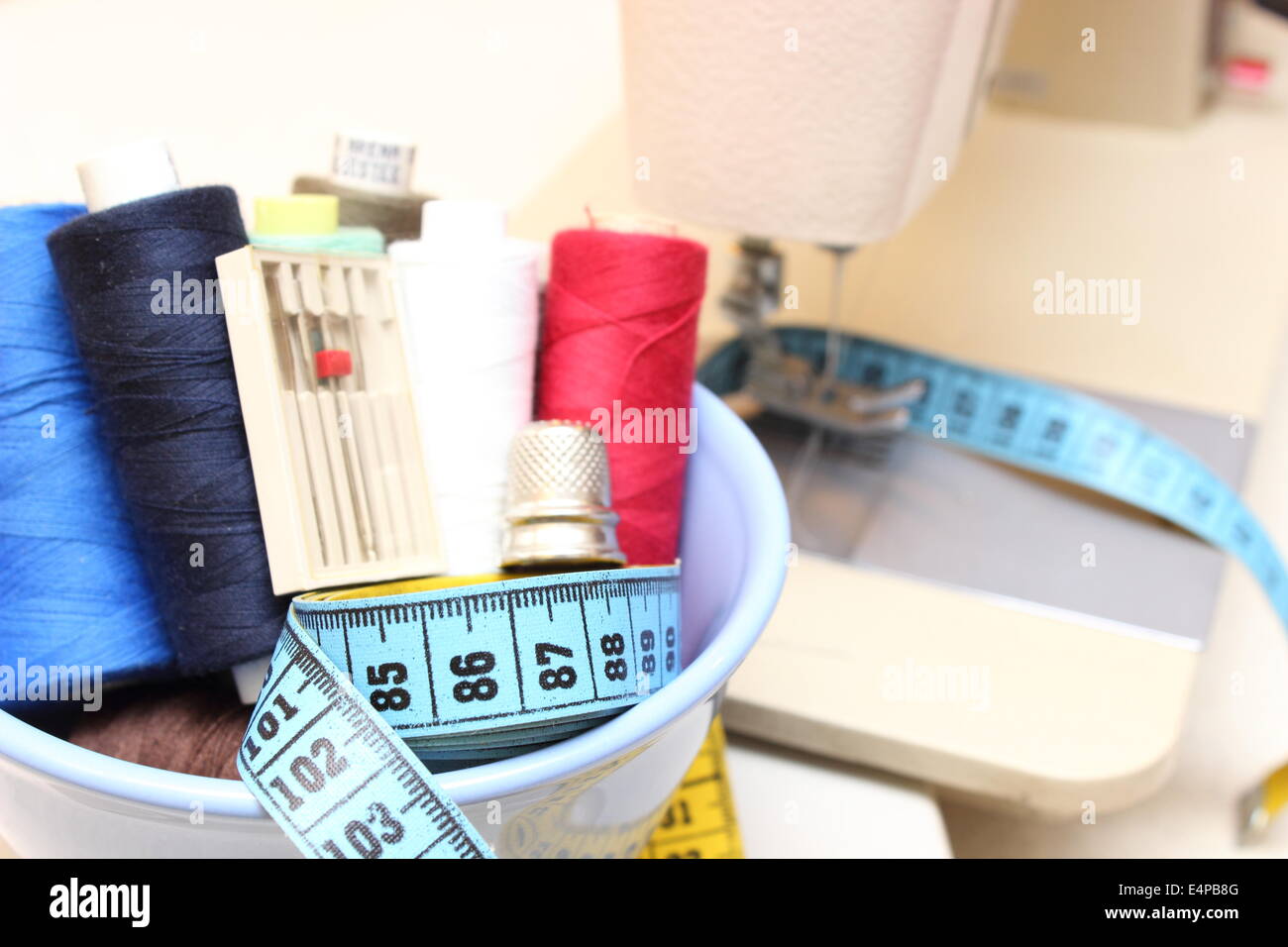 Colorful spools of thread with a tape measure and thimble Stock Photo ...