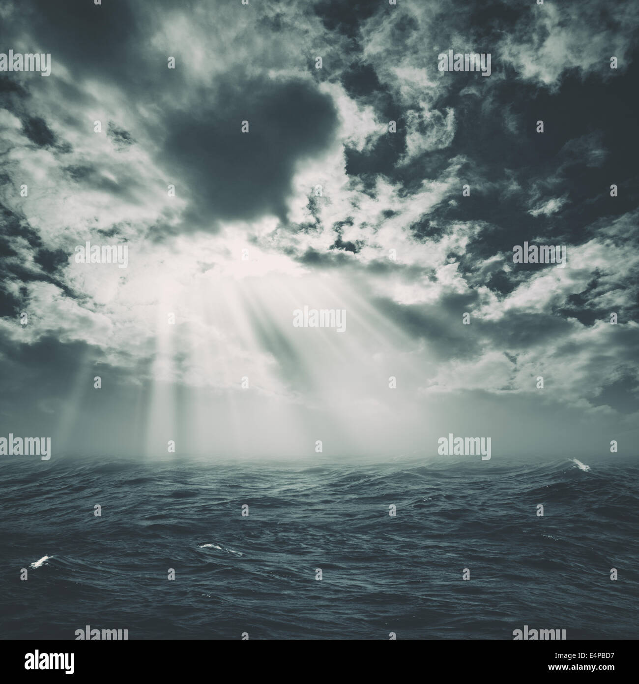 wild storm on the sea with sun beam from the cloudy skies Stock Photo