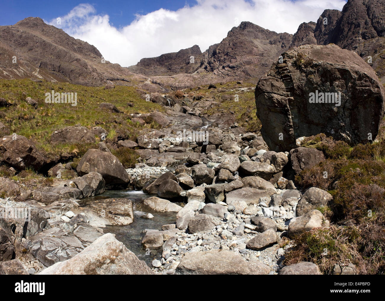 Rocky stream bed & huge boulder with the corrie of Coire Lagan in the ...