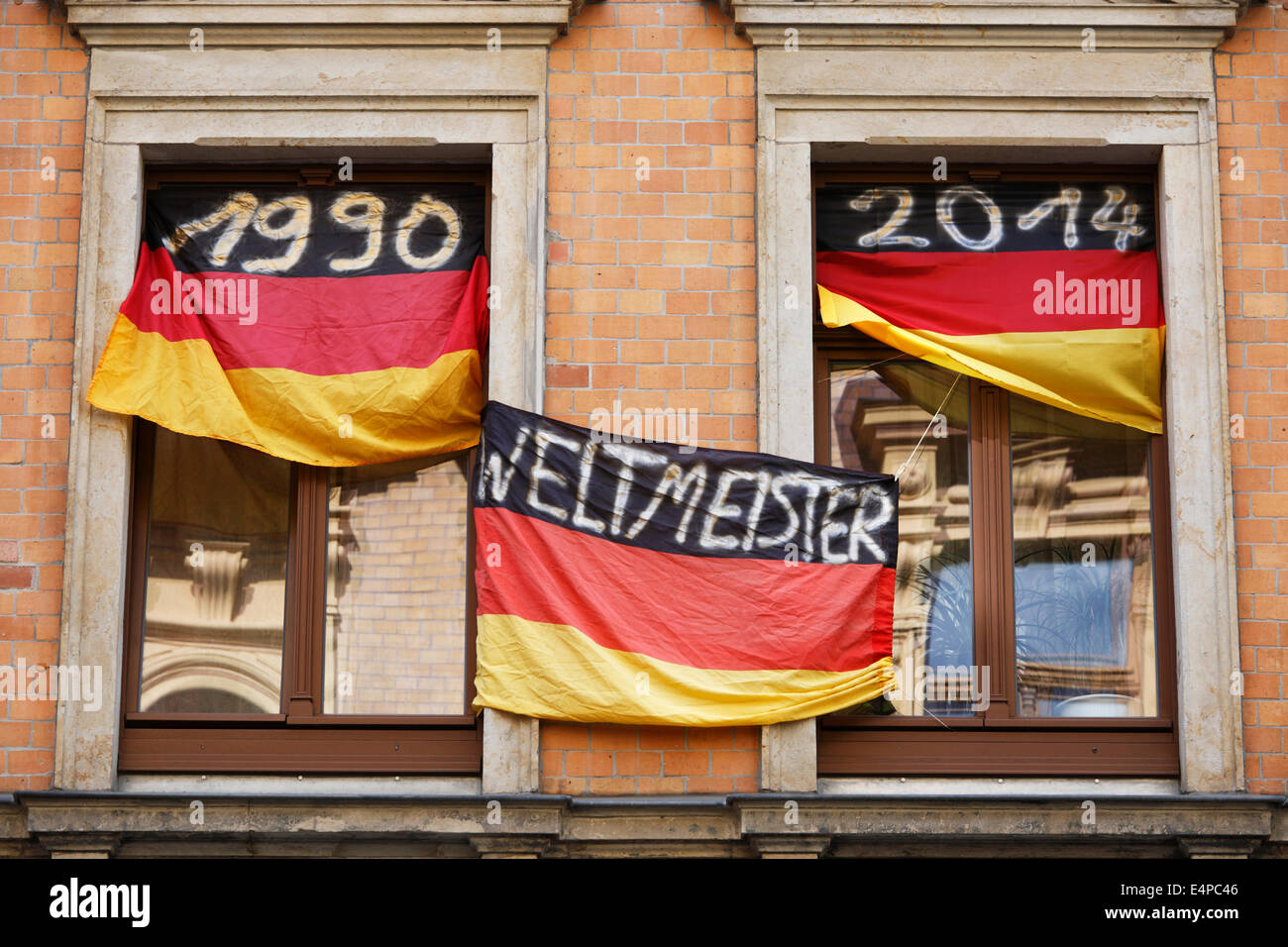 Germany Football World Champion 1954 1974 1990 and 2014; Flags with the year dates at the windows of an German fan Stock Photo