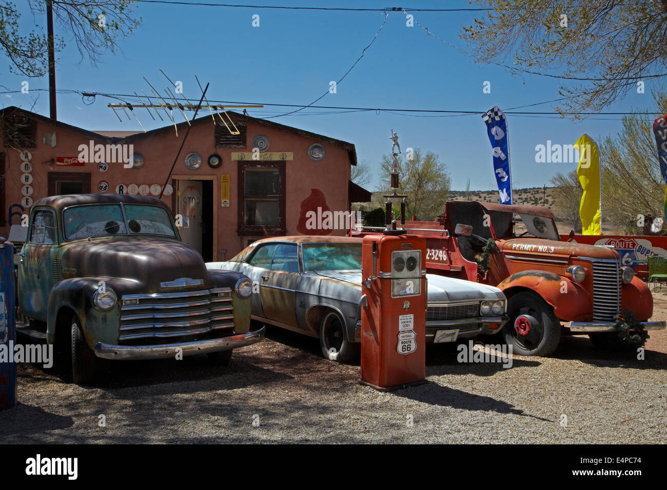 Old vehicles and gas pump behind Delgadillo's Snow Cap, Seligman, Historic U.S. Route 66, Arizona, USA Stock Photo