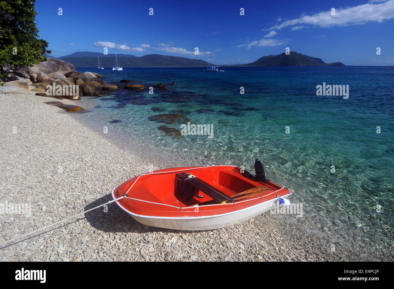 Red dinghy on coral rubble beach, Fitzroy Island, Great Barrier Reef Marine Park, Queensland, Australia. No PR Stock Photo