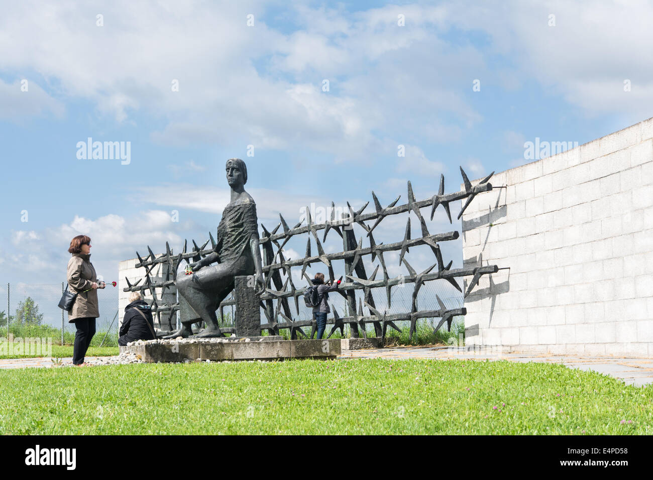Mauthausen,Austria-May 10,2014:people admire one of the more monument before entering the camp during a cloudy day Stock Photo
