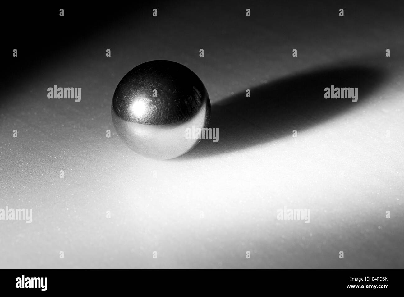 Abstract shot of a silver color metal ball bearing on a white background Stock Photo