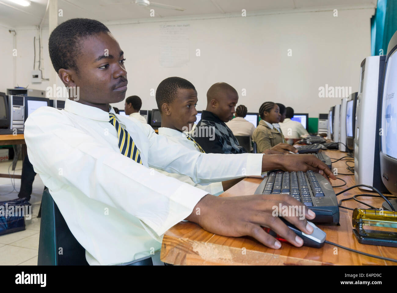 Young people working on computers, classroom, township, St. Lucia Estuary, Elephant Coast, KwaZulu-Natal, South Africa Stock Photo