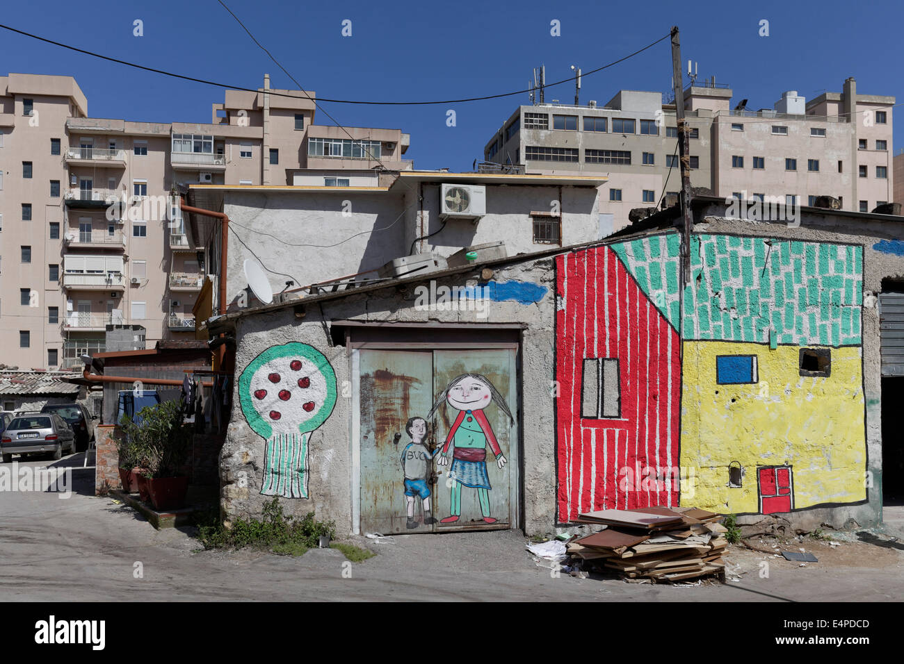 Brightly painted huts in front of modern residential buildings, historic quarter of Borg Vecchio, Palermo, Province of Palermo Stock Photo
