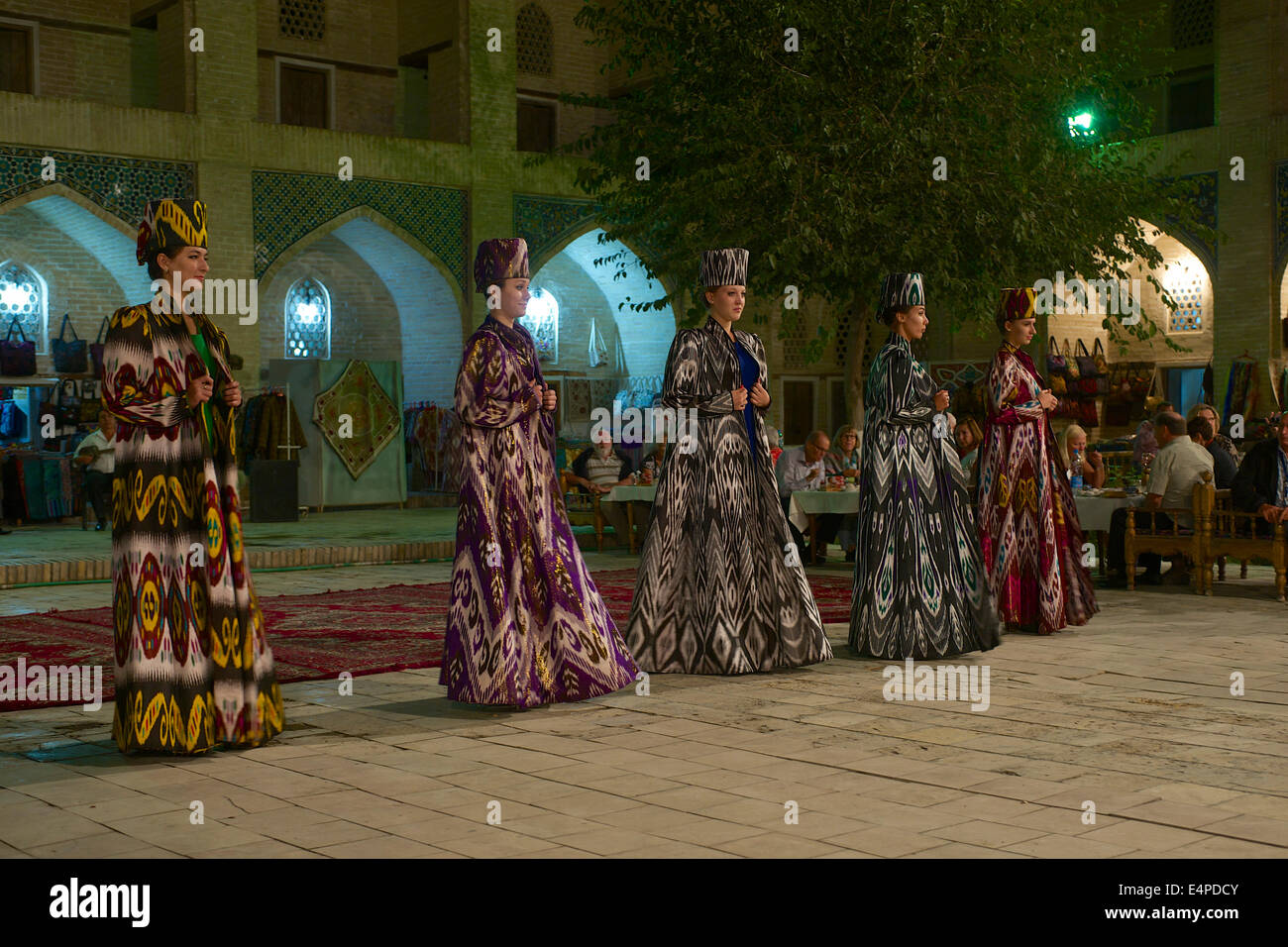 Evening event with local food and dancing, Nadir Divan-Beghi madrasah, Bukhara, Uzbekistan Stock Photo