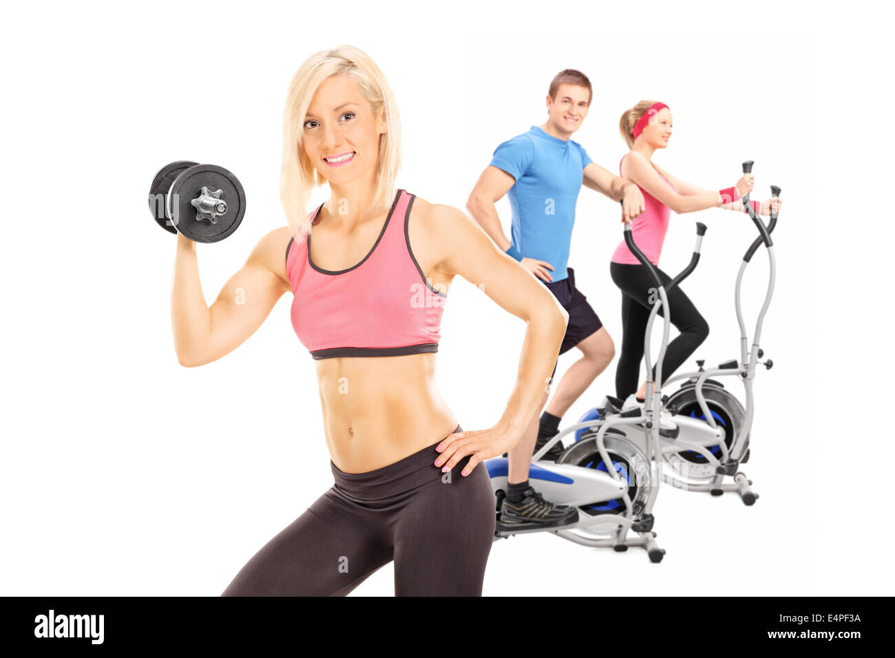 Three athletes exercising with fitness equipment Stock Photo