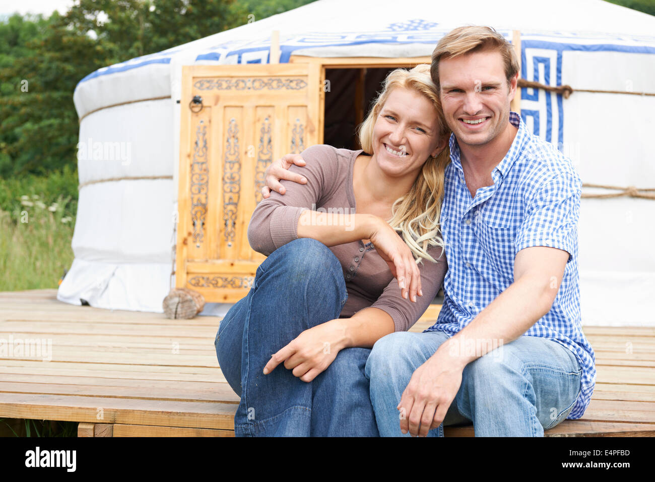Couple Enjoying Camping Holiday In Traditional Yurt Stock Photo