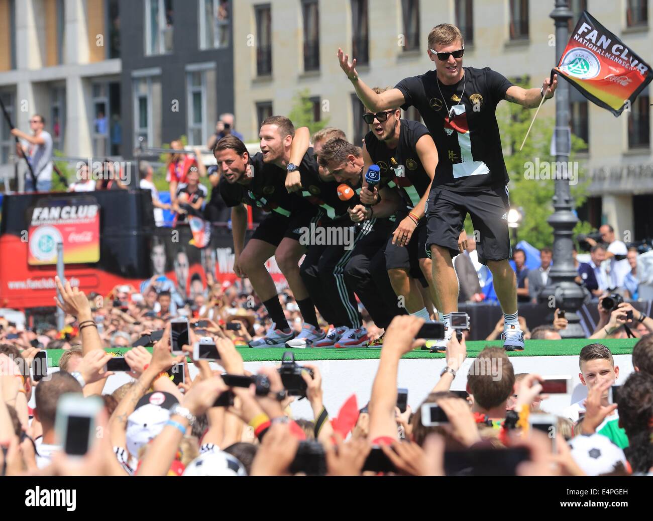 Germany's Toni Kroos (R-L), Mario Goetze, Miroslav Klose, Andre Schuerrle, Shkodran Mustafi and Roman Weidenfeller cheer and celebrate on stage during the welcome reception for Germany's national soccer team in front of the Brandenburg Gate, Berlin, Germany, 15 July 2014. The German team won the Brazil 2014 FIFA Soccer World Cup final against Argentina by 1-0 on 13 July 2014, winning the world cup title for the fourth time after 1954, 1974 and 1990. Photo: Jens Wolf/dpa Stock Photo