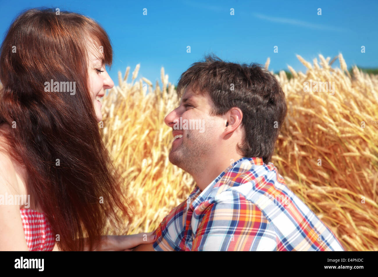 Man and woman on a wheat field Stock Photo - Alamy