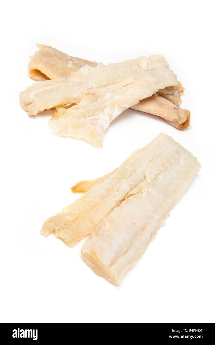 Pieces of salt cod fish isolated on a white studio background Stock