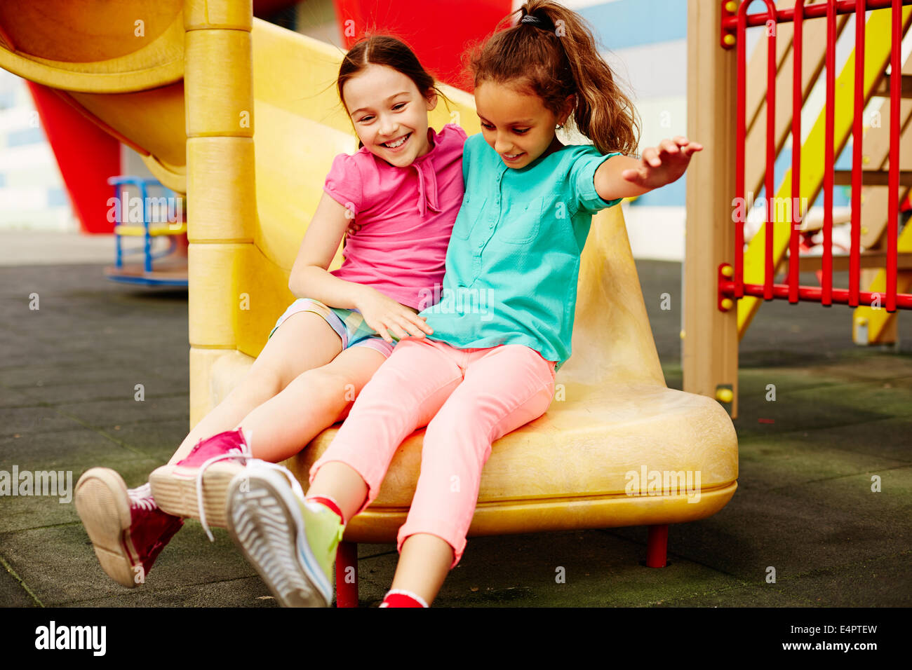 Image of two friendly girls having fun on playground Stock Photo - Alamy
