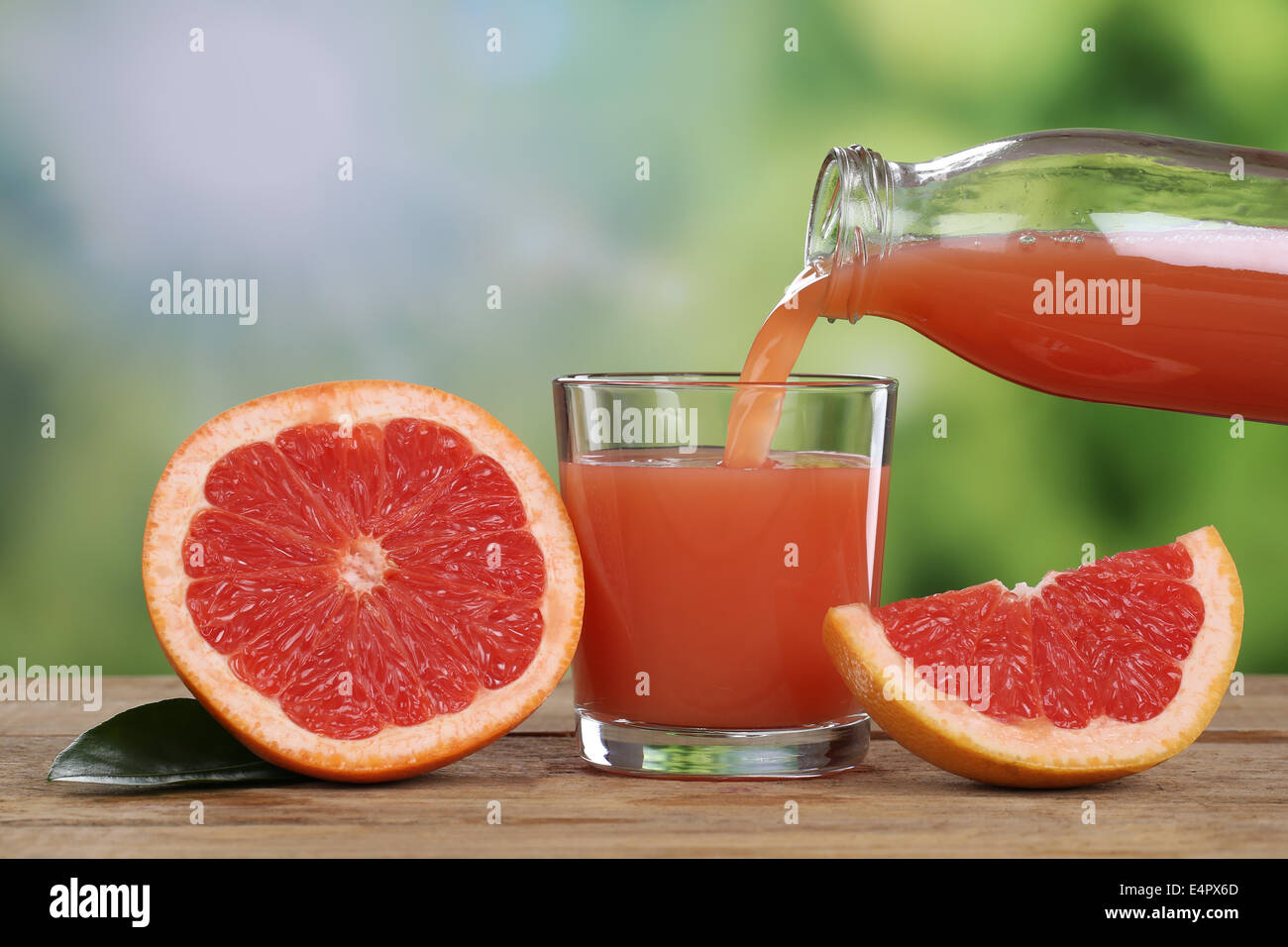Grapefruit juice pouring in summer into a glass Stock Photo