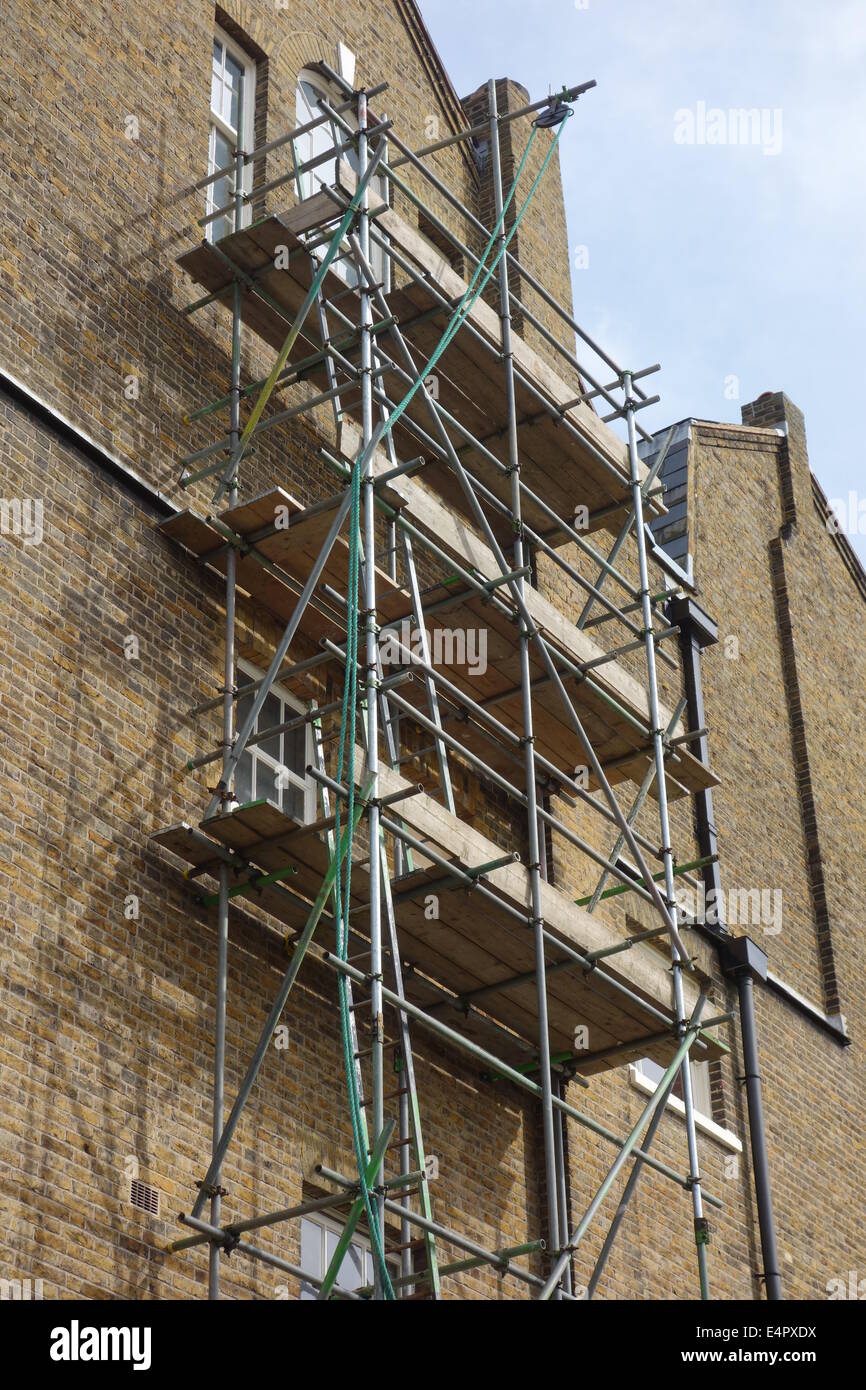 Scaffolding on Tall Brick Building Stock Photo