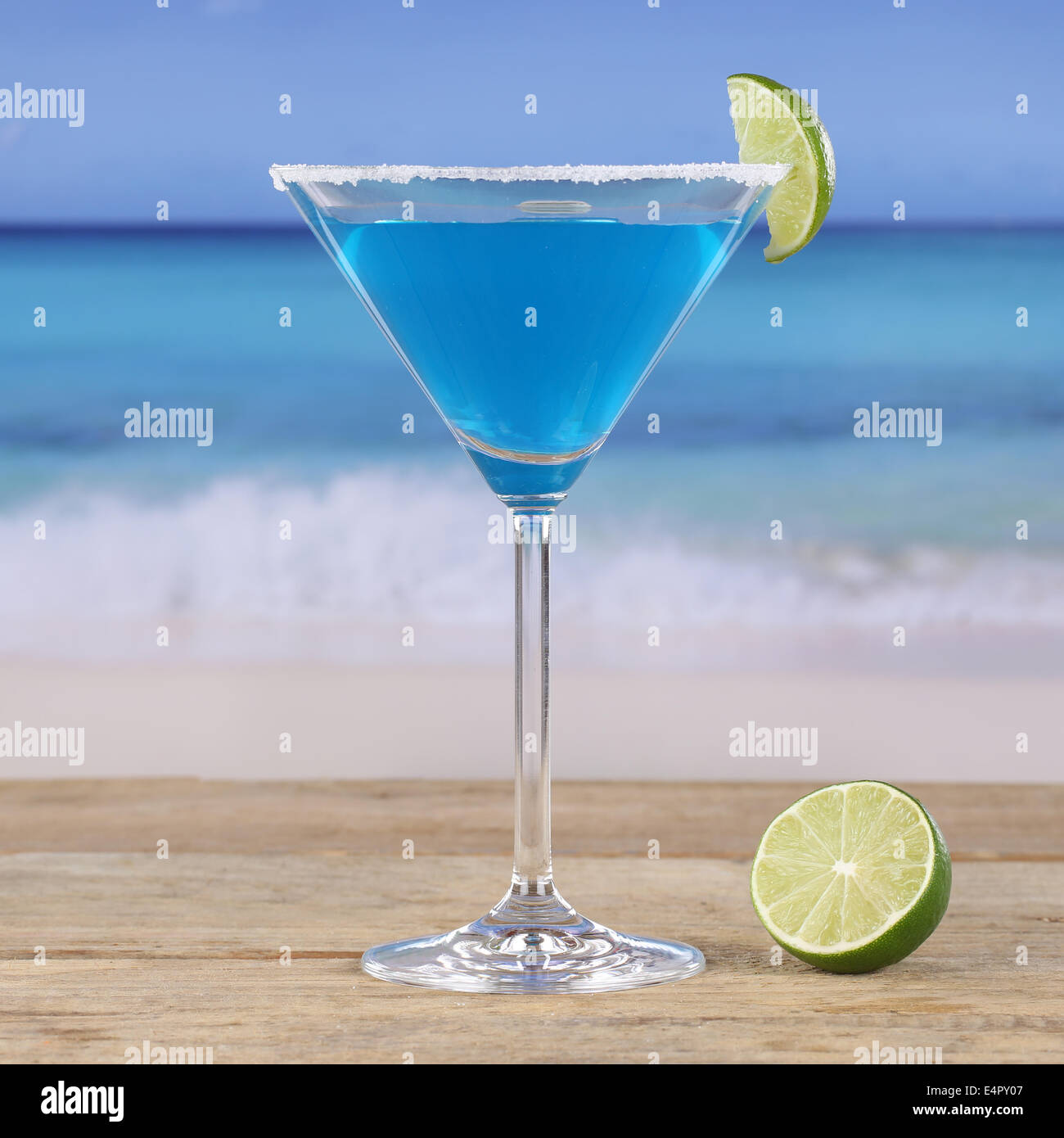 Blue Curacao cocktail drink on the beach and sea Stock Photo