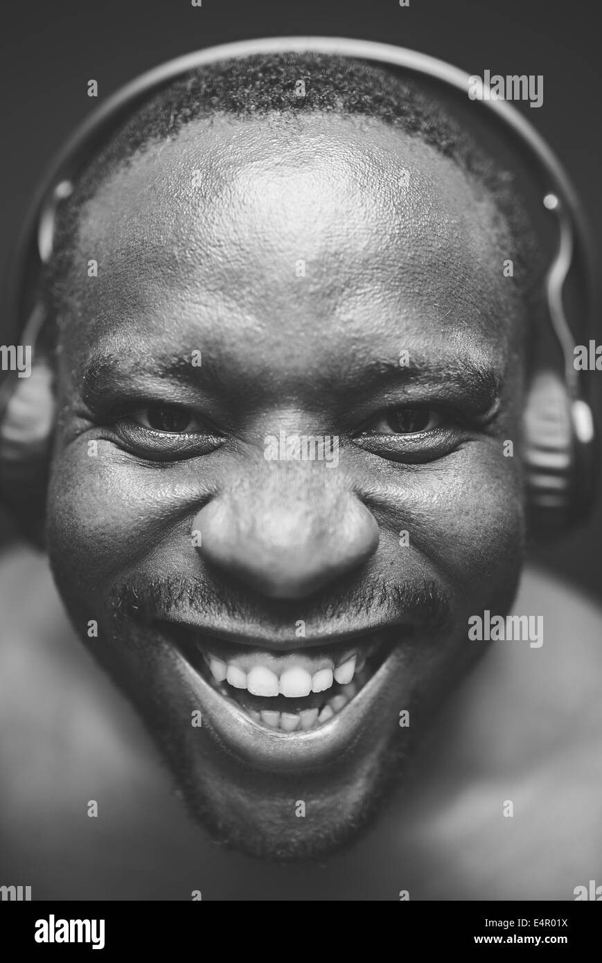 AfricanAmerican guy with headphones looking at camera with smile Stock