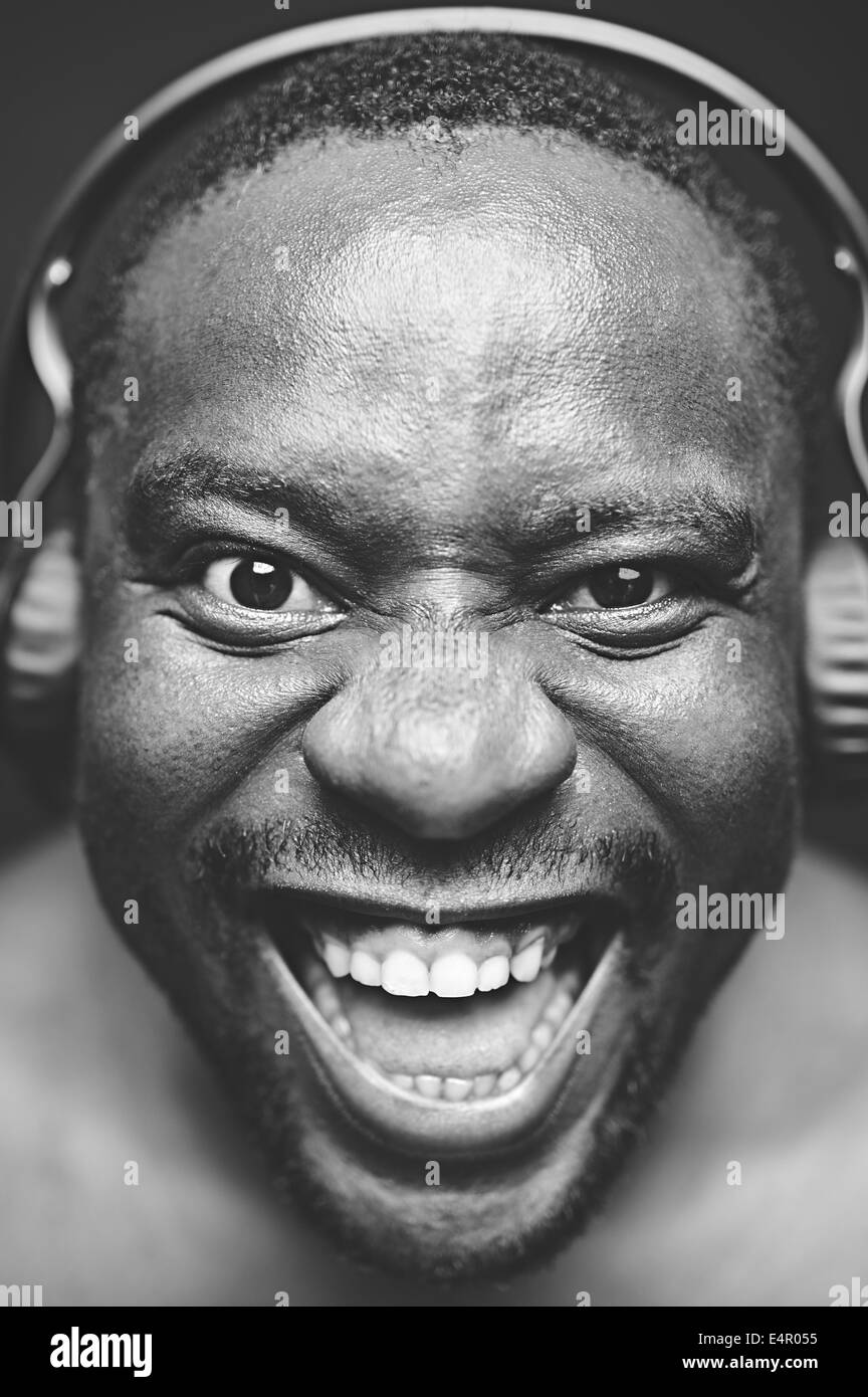 AfricanAmerican guy with headphones looking at camera and laughing