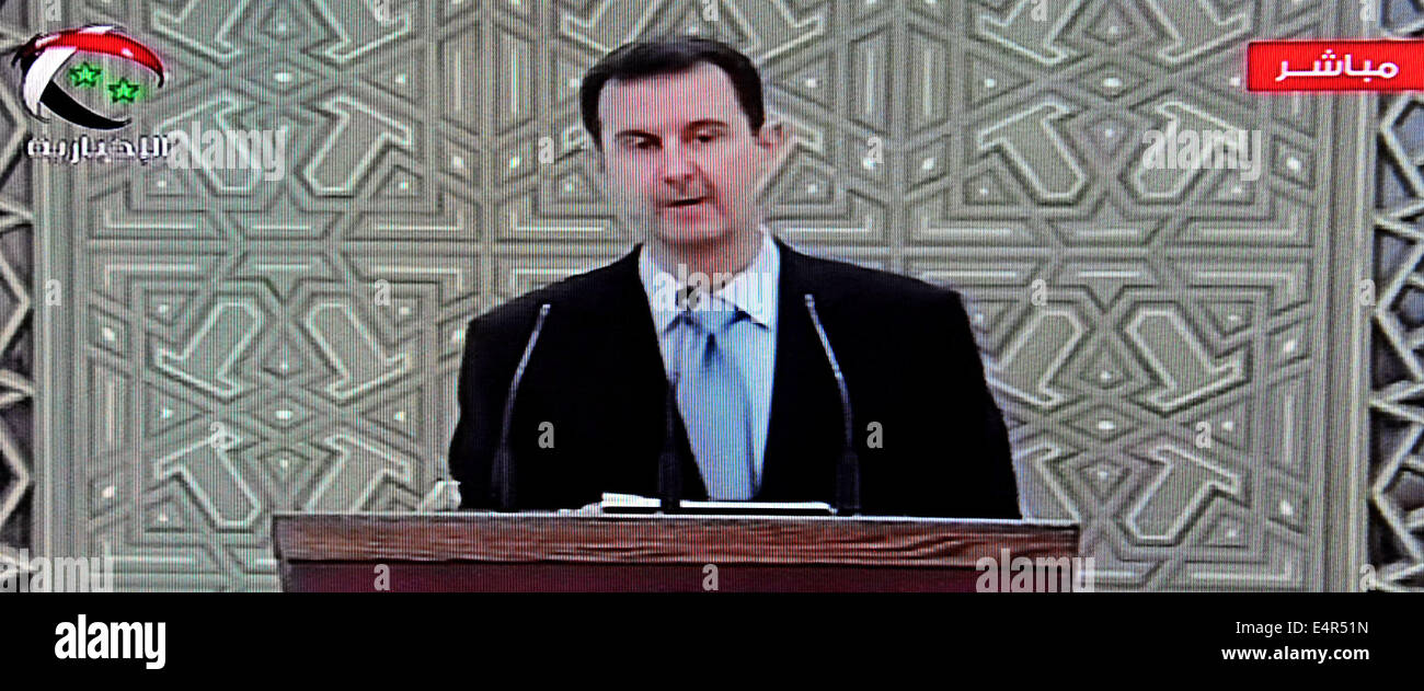 (140716) -- DAMASCUS, July 16, 2014 (Xinhua) -- Image from the state-run television shows Syrian President Bashar al-Assad  was invited to podium to take the oath during the swearing-in ceremony in Damascus, July 16, 2014. The swearing-in ceremony of President Bashar al-Assad began Wednesday and it will be followed by an inauguration speech, in which Assad will outline the features of his new seven-year-term in office. (Xinhua/Zhang Naijie) Stock Photo