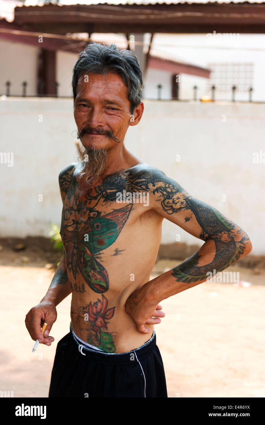 Portrait of non traditional Laotian man with tattoos in Vientiane. Stock Photo