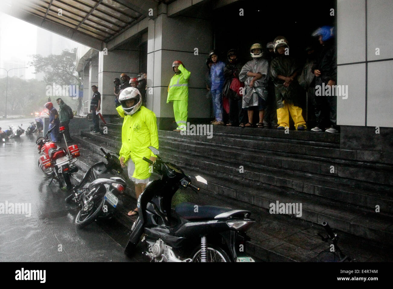 Manila, Philippines. 16th July, 2014. Motorcycle wait for the rain and wind to subside as Typhoon Rammasun hit Metro Manila. Typhoon Rammasun (locally known as Glenda) had maximum sustained winds of 150 kph and gustiness of up to 185 kph when it hit Metro Manila. Across the country, about 400,000 people had fled their homes and sheltered in evacuation centers, according to the disaster management council. © PACIFIC PRESS/Alamy Live News Stock Photo