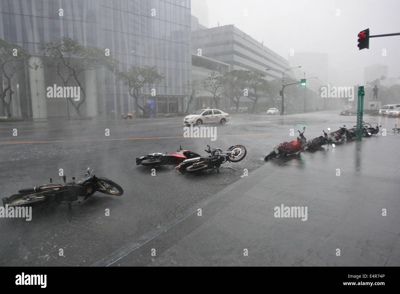 Manila, Philippines. 16th July, 2014. Motorcycles lie on the road toppled by strong winds as Typhoon Rammasun hit Metro Manila. Typhoon Rammasun (locally known as Glenda) had maximum sustained winds of 150 kph and gustiness of up to 185 kph when it hit Metro Manila. Across the country, about 400,000 people had fled their homes and sheltered in evacuation centers, according to the disaster management council. © PACIFIC PRESS/Alamy Live News Stock Photo