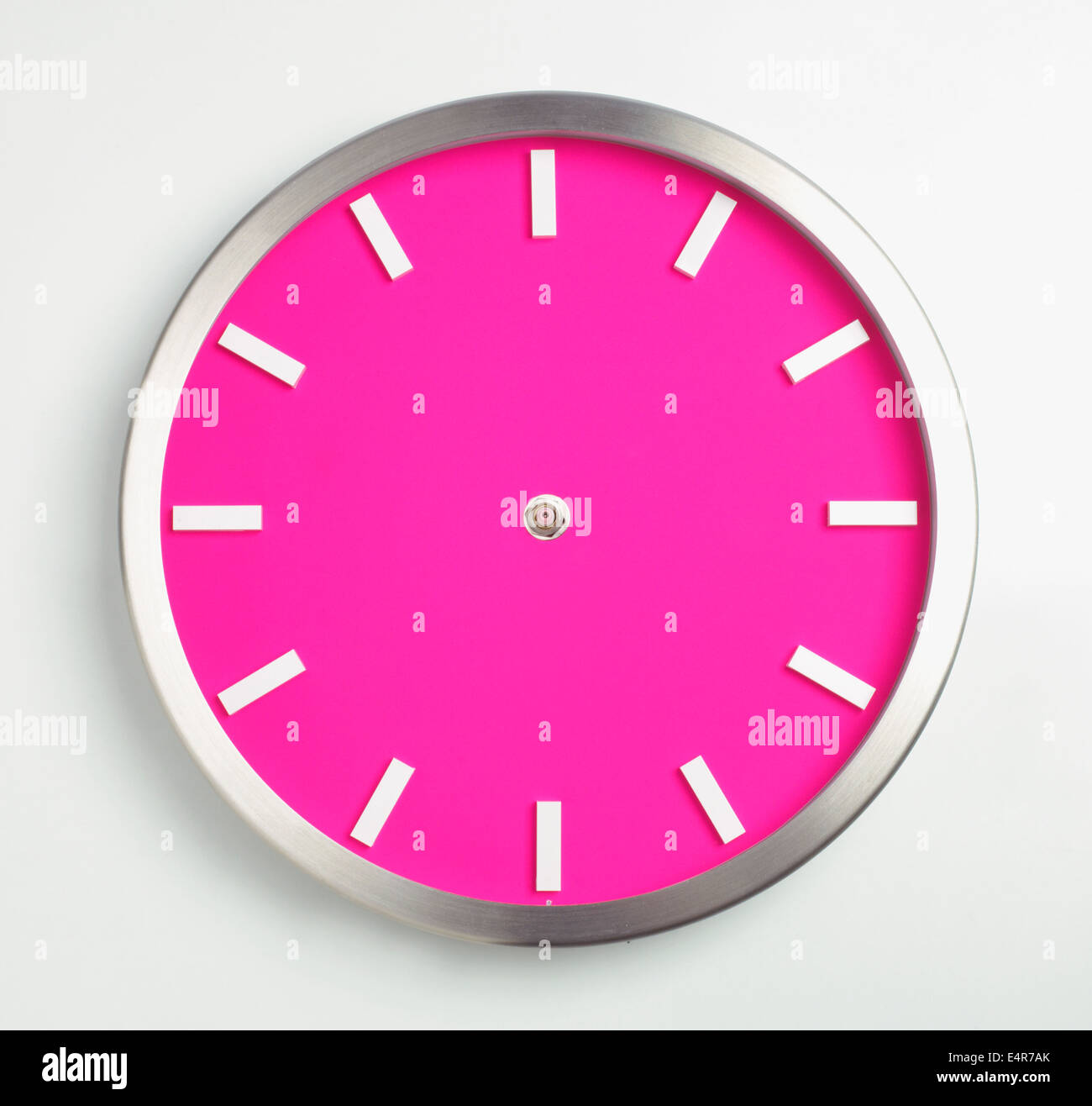 Pink wall clock with hands missing Stock Photo