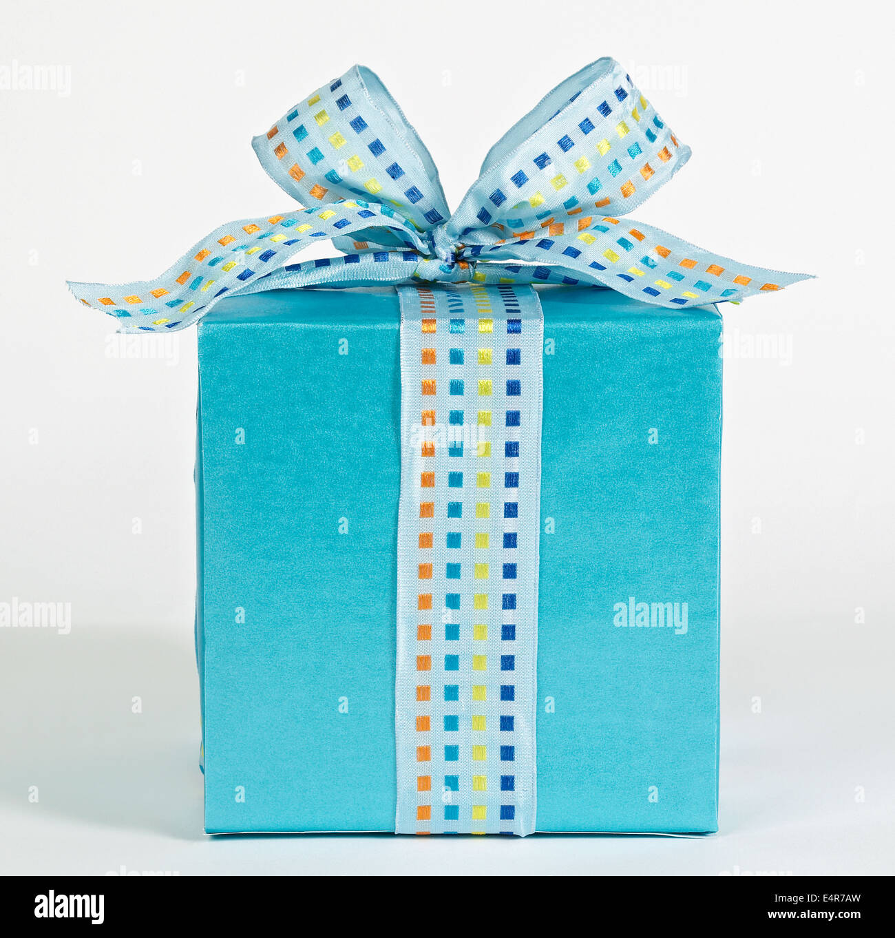 Blue gift box with multicoloured ribbon Stock Photo